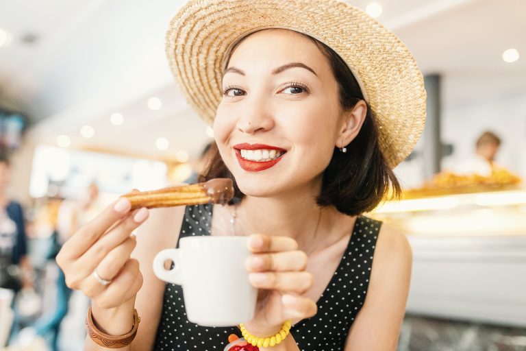 Happy,Cheerful,Girl,In,Hat,Eating,Traditional,Spanish,Delicious,Churros,