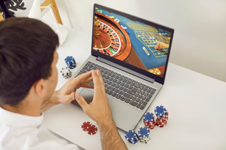 Young,Man,Playing,Poker,On,An,Online,Casino,Club,Website.