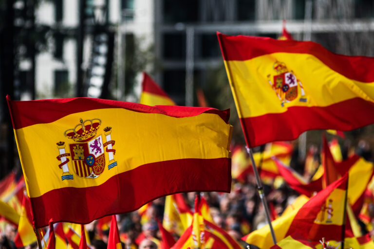 Spanish,Flags,Waving,During,A,Protest,For,The,Unity,Of