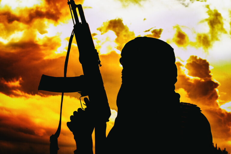 Muslim,Militant,With,Rifle,In,The,Desert,On,Sunset,With